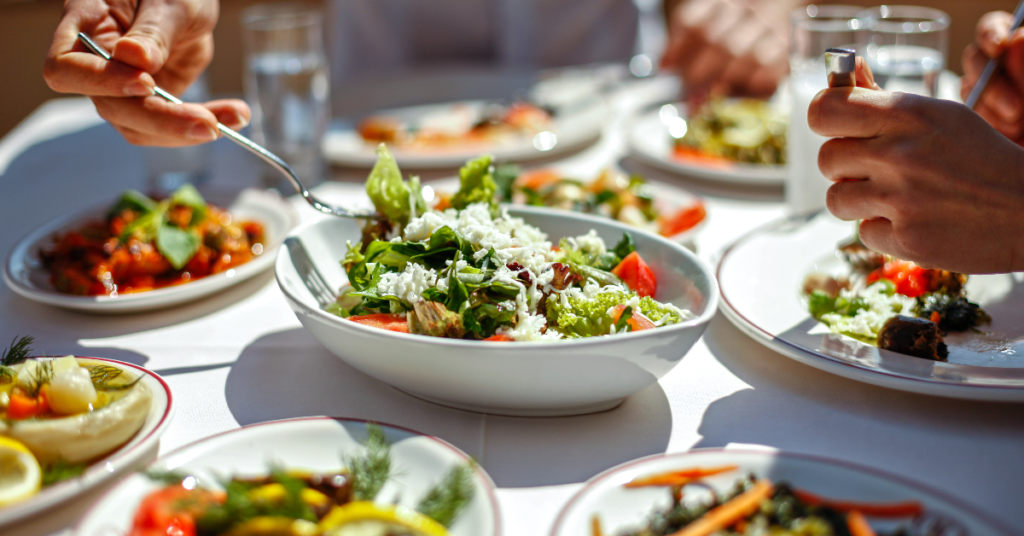 A vibrant salad bowl with fresh vegetables on a dining table, promoting healthy eating to boost immunity and prevent the common cold and flu.