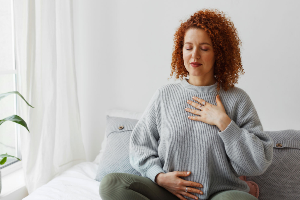 Person practicing deep breathing exercises as part of a sleep apnea bedtime routine to promote relaxation and better sleep.