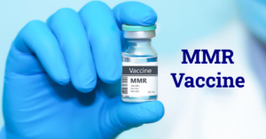 A gloved hand holding a vial labeled MMR Vaccine, representing vaccination for measles, mumps, and rubella.