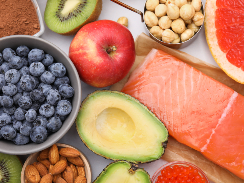 Balanced diet for hormonal weight gain management with salmon, avocado, blueberries, and nuts.