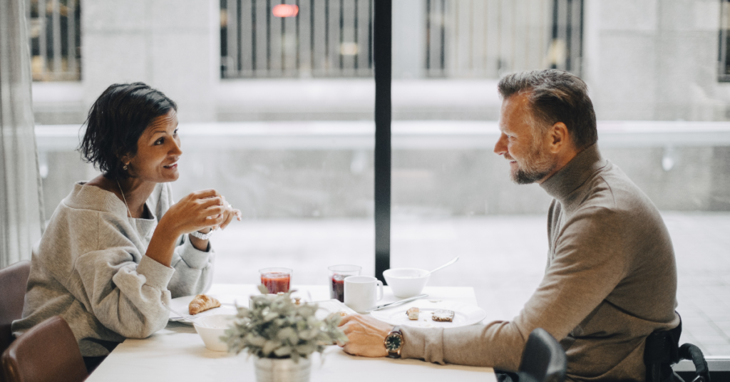 A couple sitting together at a table, communicating effectively over breakfast.