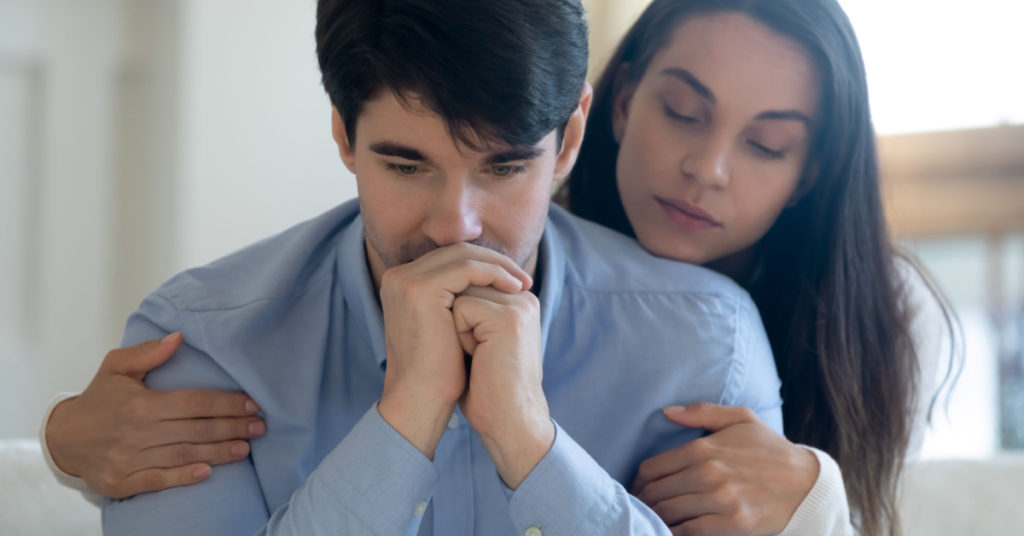 A woman comforting her partner, showcasing empathy and support in a relationship.