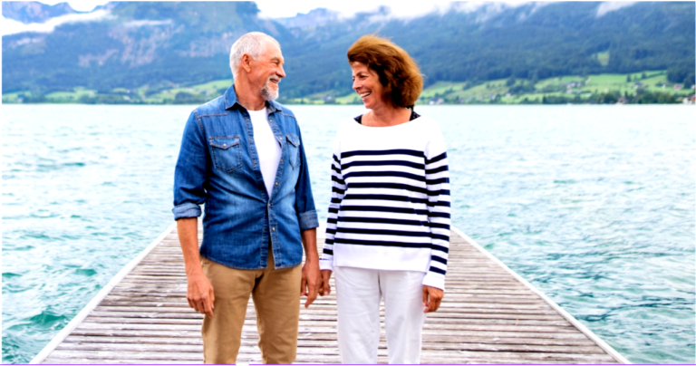 A happy couple on a dock symbolizing an emotionally strong husband and a healthy marriage.