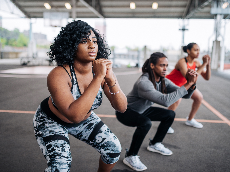 Women and men engaging in a group workout session, promoting heart-healthy physical activity.