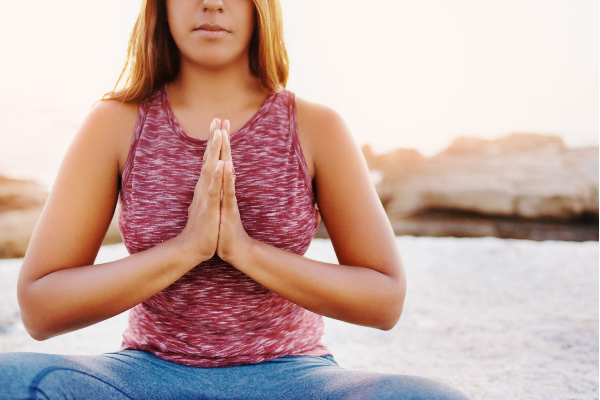 Woman practicing mindfulness through meditation to manage anxiety naturally