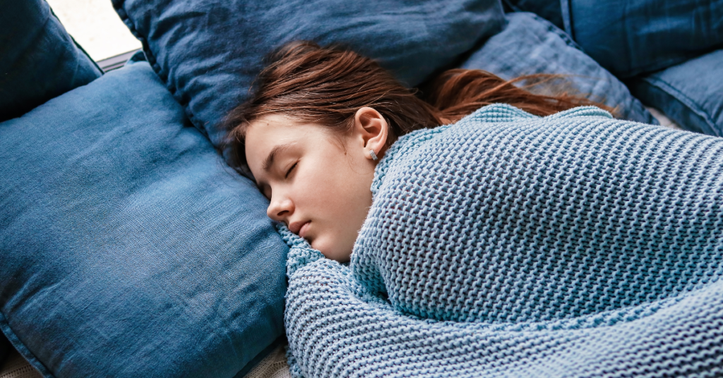 A young woman sleeping peacefully, highlighting vitality tips for women through quality sleep.