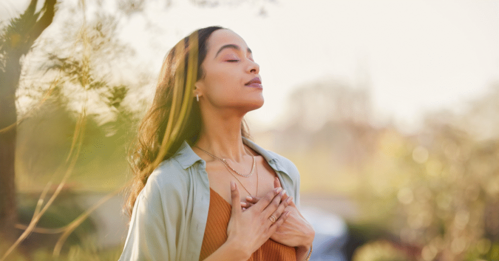A woman meditating in a peaceful morning setting, emphasizing the importance of mindfulness and quiet time for a focused and calm start to the day.